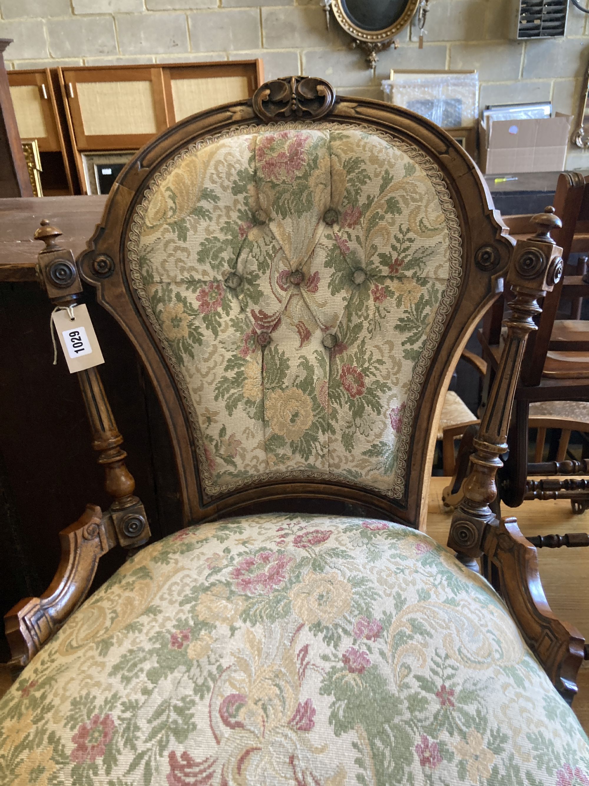 A Victorian carved walnut spoon back nursing chair, width 54cm, depth 56cm, height 80cm